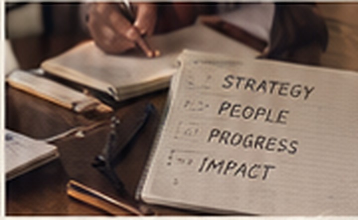 Notebook with strategy, people, progress, and impact handwritten on the page